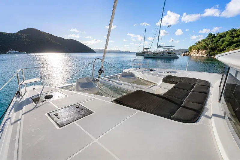 Echo Yacht Photos Pics 2023 Lagoon 50 catamaran on serene water with scenic mountain backdrop.
