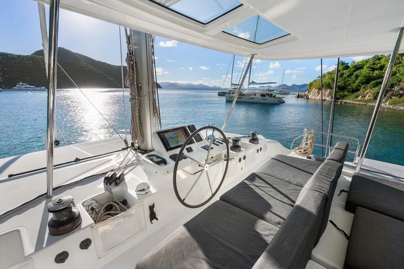 Echo Yacht Photos Pics 2023 Lagoon 50 catamaran cockpit with scenic ocean view and luxurious seating.