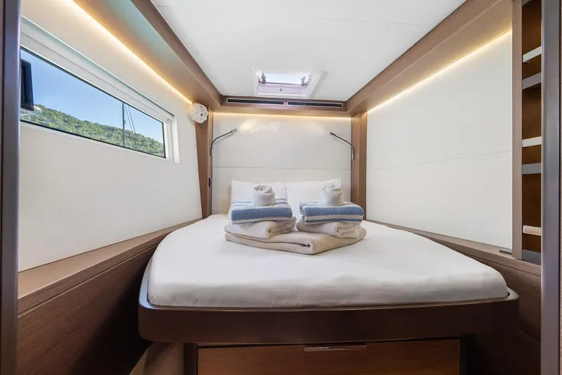 Echo Yacht Photos Pics Luxurious cabin interior of 2023 Lagoon 50 yacht with neatly arranged towels.