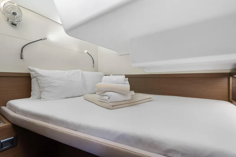 Echo Yacht Photos Pics Luxurious cabin interior of 2023 Lagoon 50 yacht with neatly arranged bedding.
