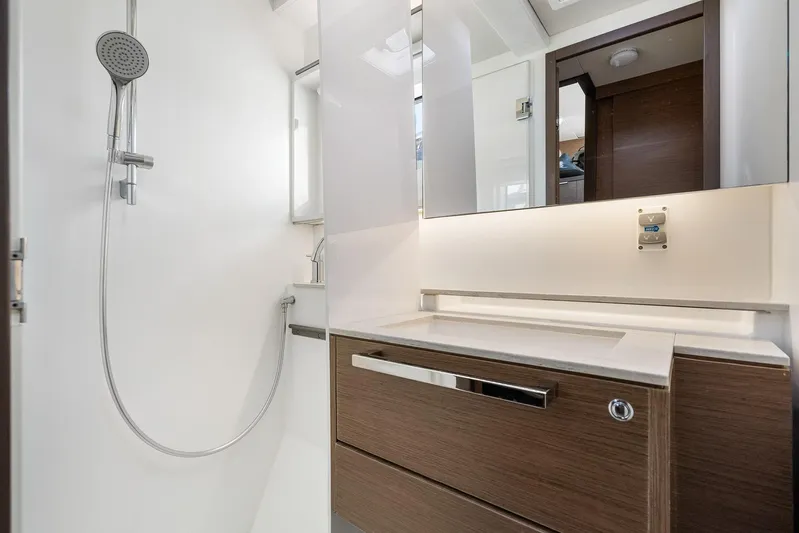 Echo Yacht Photos Pics Modern bathroom interior in 2023 Lagoon 50 yacht, featuring sleek shower and vanity.