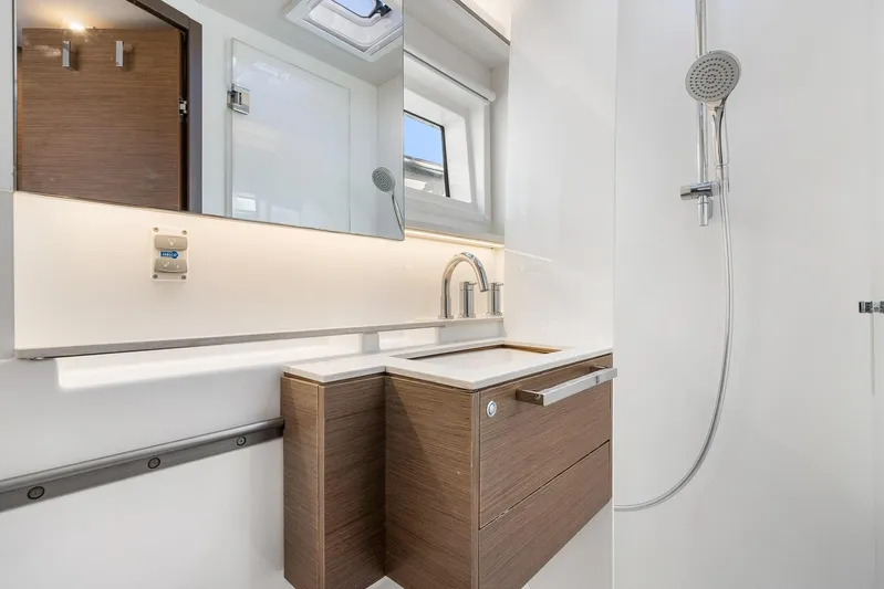 Echo Yacht Photos Pics Modern bathroom in 2023 Lagoon 50 yacht with sleek fixtures and wooden cabinetry.