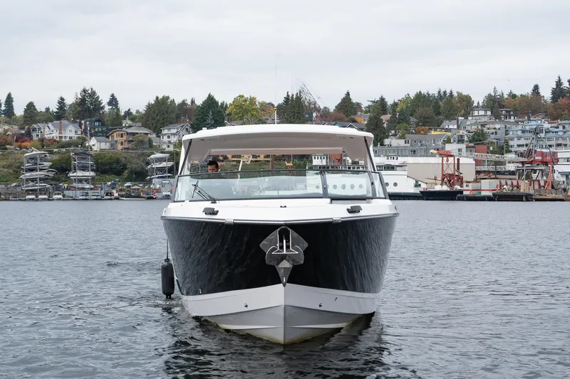  Yacht Photos Pics 2024 Aviara AV40 I/O boat on water with scenic waterfront background.