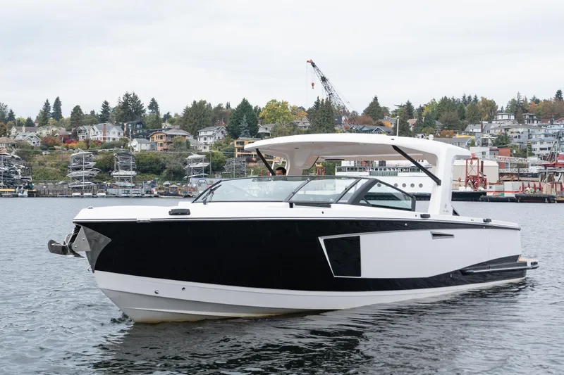  Yacht Photos Pics 2024 Aviara AV40 I/O luxury boat cruising on a scenic waterfront.