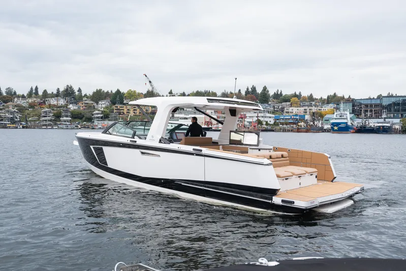  Yacht Photos Pics 2024 Aviara AV40 I/O luxury boat cruising on a scenic waterfront.