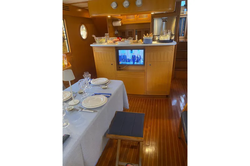  Yacht Photos Pics Luxurious interior of 2005 Selene 47 yacht with elegant dining setup and wooden finishes.