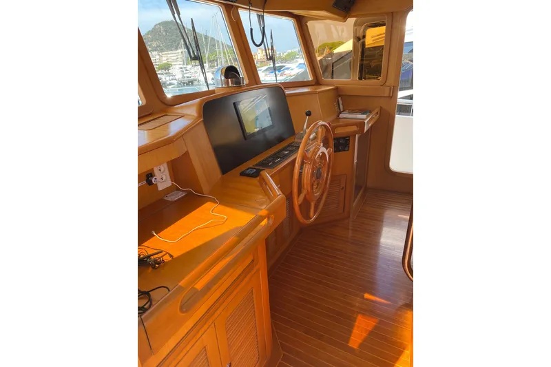  Yacht Photos Pics 2005 Selene 47 yacht interior with wooden helm and navigation equipment.