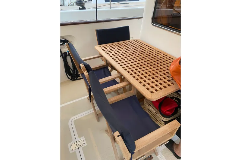  Yacht Photos Pics Teak table and chairs on 2005 Selene 47 yacht deck.