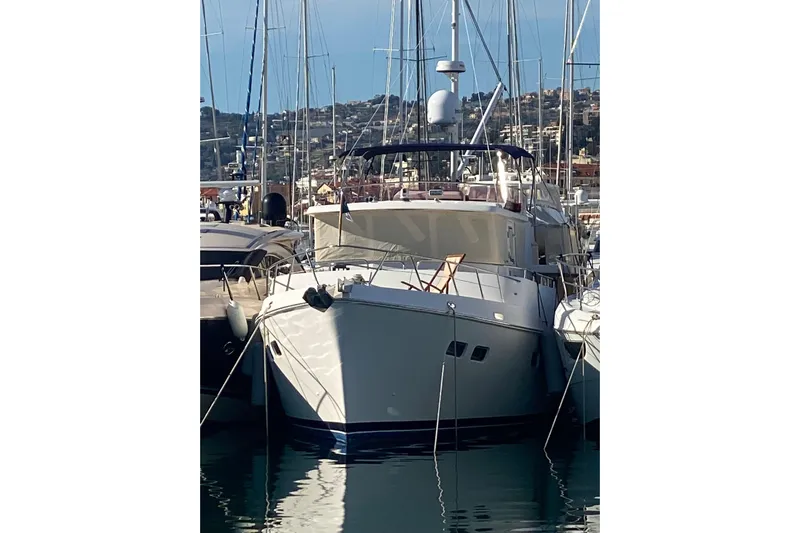  Yacht Photos Pics Selene 47 yacht from 2005 docked in a marina, surrounded by sailboats.