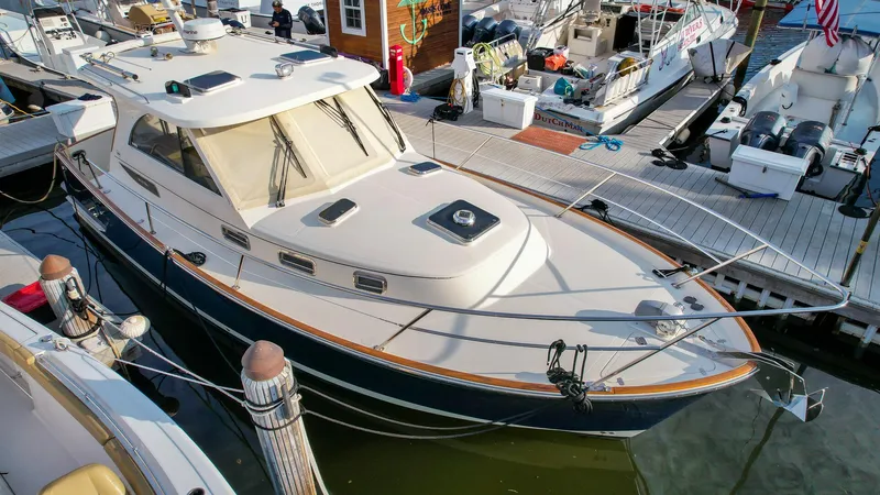 Gyspy Baby Yacht Photos Pics 2007 Legacy 32 boat docked at marina, surrounded by other vessels.