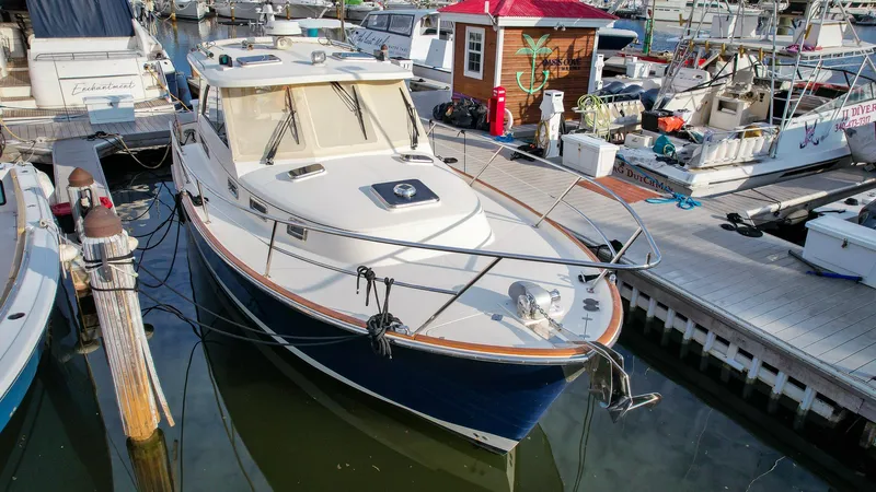 Gyspy Baby Yacht Photos Pics 2007 Legacy 32 boat docked at marina, surrounded by other vessels.