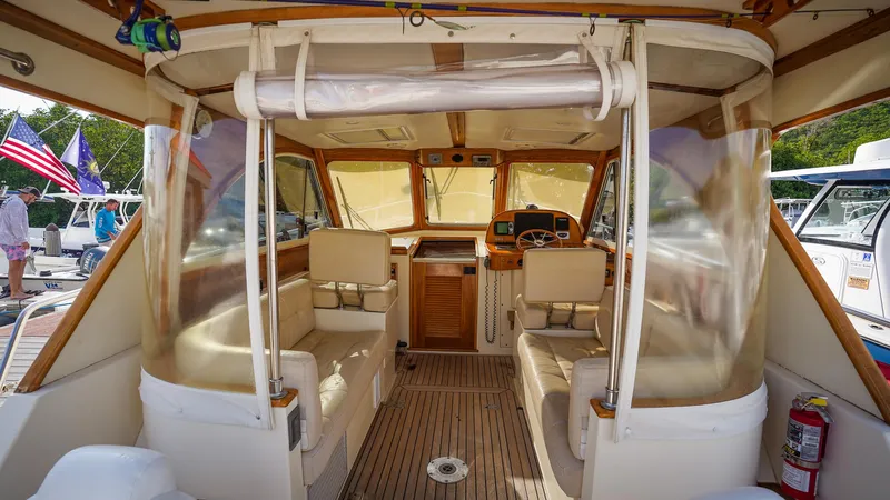 Gyspy Baby Yacht Photos Pics Interior of 2007 Legacy 32 boat with seating and helm, docked at marina.