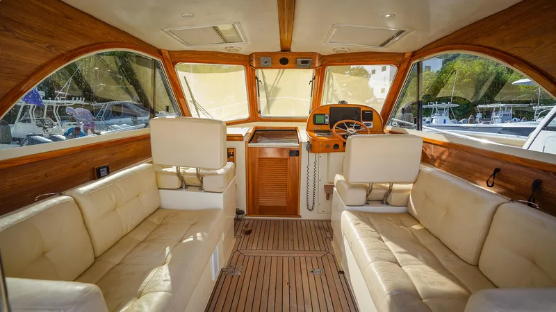 Gyspy Baby Yacht Photos Pics Luxurious interior of a 2007 Legacy 32 boat with plush seating and wooden accents.