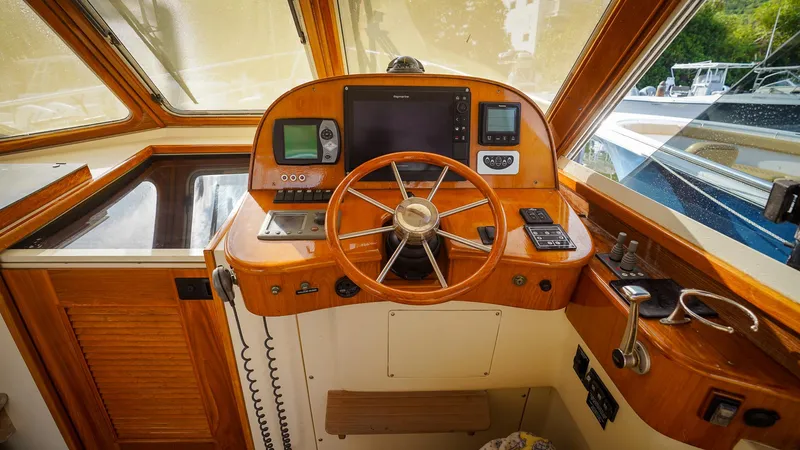 Gyspy Baby Yacht Photos Pics 2007 Legacy 32 boat helm with wooden steering wheel and navigation equipment.