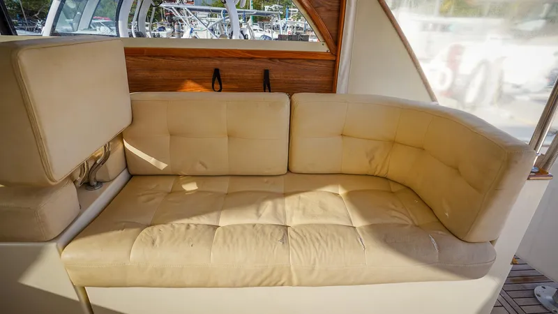 Gyspy Baby Yacht Photos Pics Beige cushioned seating in 2007 Legacy 32 boat interior.
