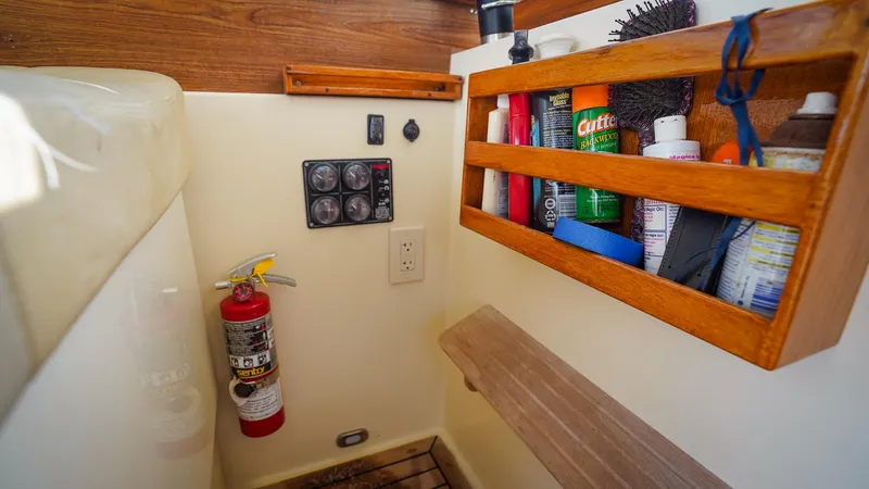 Gyspy Baby Yacht Photos Pics Compact boat interior with storage shelves, fire extinguisher, and control panel in a 2007 Legacy 32.