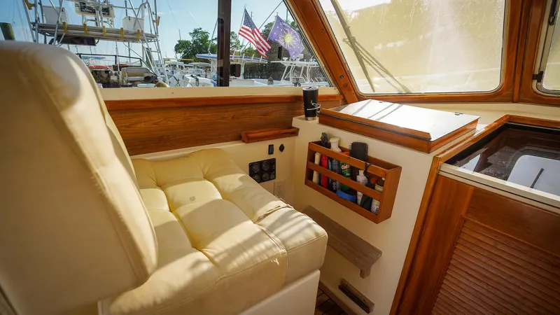 Gyspy Baby Yacht Photos Pics Interior of 2007 Legacy 32 boat with beige seating and wooden accents.