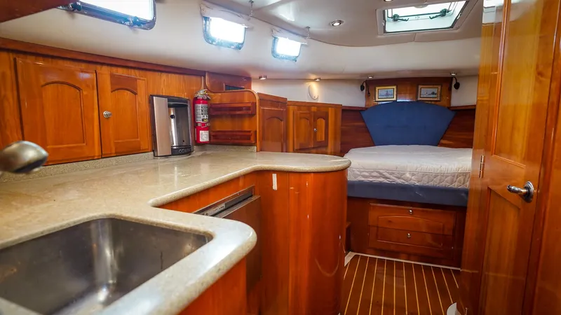 Gyspy Baby Yacht Photos Pics Luxurious 2007 Legacy 32 yacht interior with wood finish and cozy sleeping area.