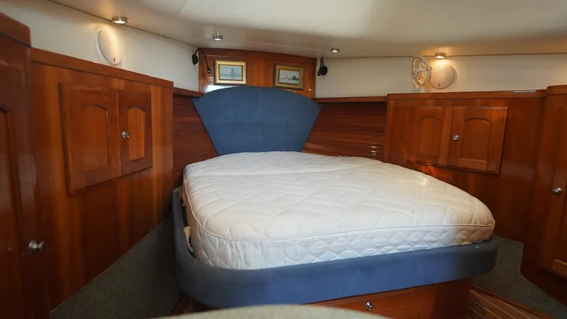 Gyspy Baby Yacht Photos Pics Luxurious cabin interior of 2007 Legacy 32 yacht with wooden cabinetry and cozy bed.