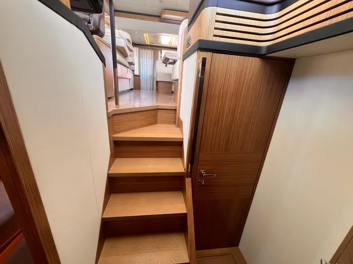  Yacht Photos Pics Staircase inside 2018 Absolute 52 Navetta yacht, featuring wooden steps and modern design.