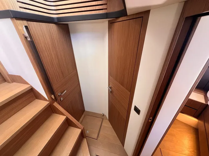  Yacht Photos Pics Interior of 2018 Absolute 52 Navetta yacht, featuring wooden doors and stairs.