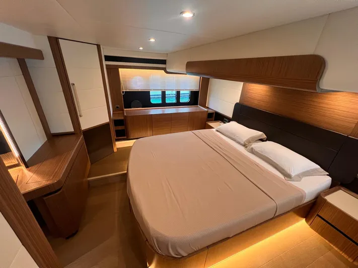 Yacht Photos Pics Luxurious bedroom interior of 2018 Absolute 52 Navetta yacht with modern wood finishes.