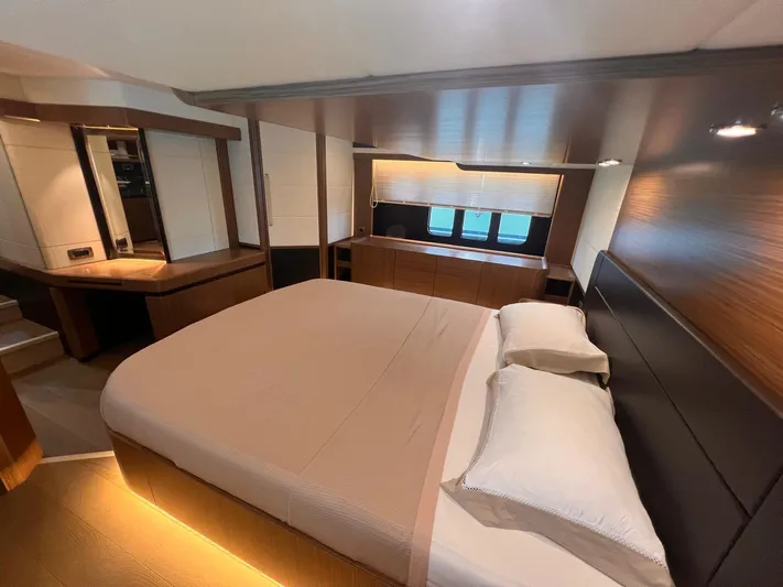  Yacht Photos Pics Luxurious bedroom interior of 2018 Absolute 52 Navetta yacht with modern design and ambient lighting.