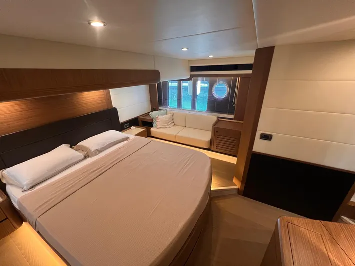  Yacht Photos Pics Luxurious cabin interior of 2018 Absolute 52 Navetta yacht with bed and seating area.