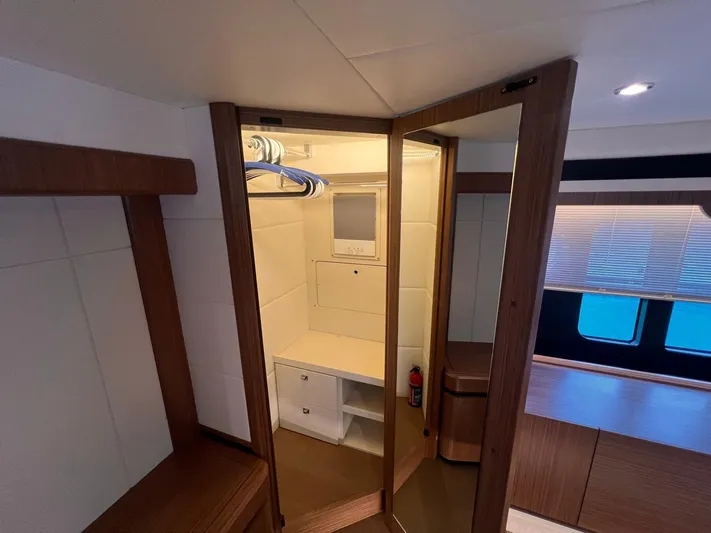  Yacht Photos Pics Interior of 2018 Absolute 52 Navetta yacht with wooden cabinetry and closet space.