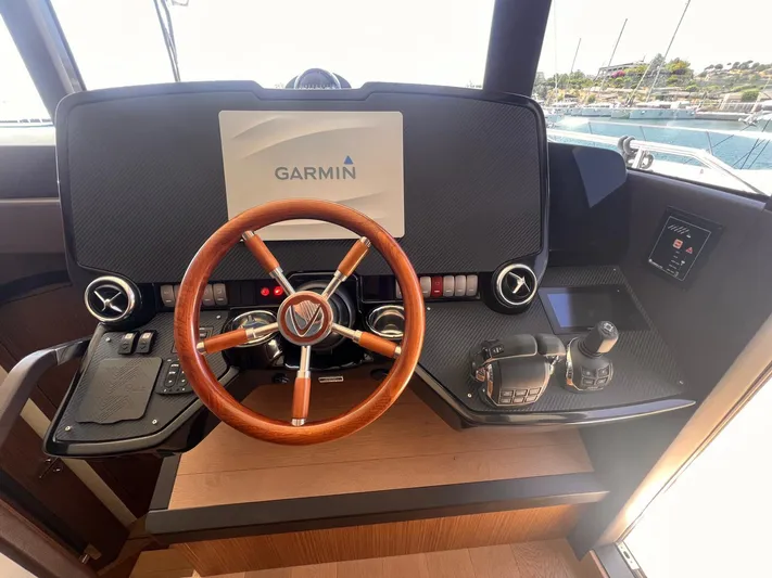  Yacht Photos Pics Cockpit of 2018 Absolute 52 Navetta yacht with Garmin navigation system and wooden steering wheel.