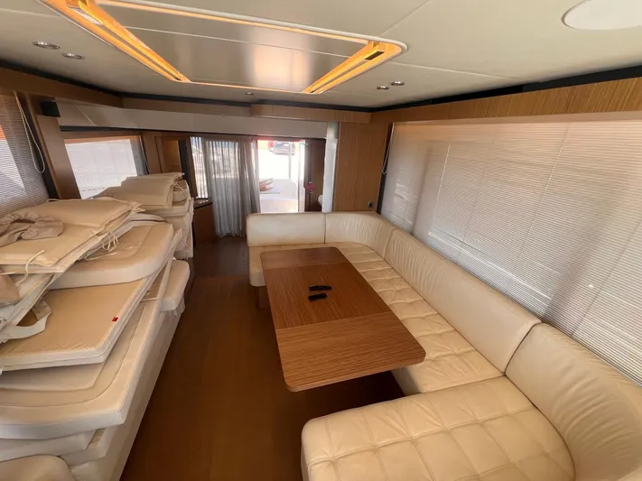  Yacht Photos Pics Luxurious interior of 2018 Absolute 52 Navetta yacht with plush seating and wooden table.