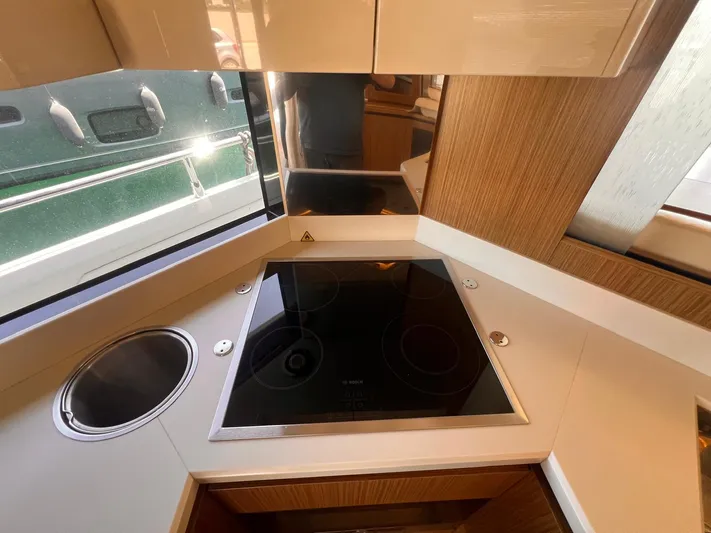  Yacht Photos Pics Modern kitchen area on 2018 Absolute 52 Navetta yacht with stove and sink.