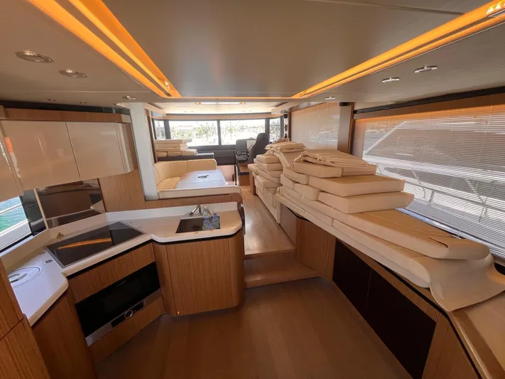  Yacht Photos Pics Luxurious interior of 2018 Absolute 52 Navetta yacht with modern kitchen and seating area.