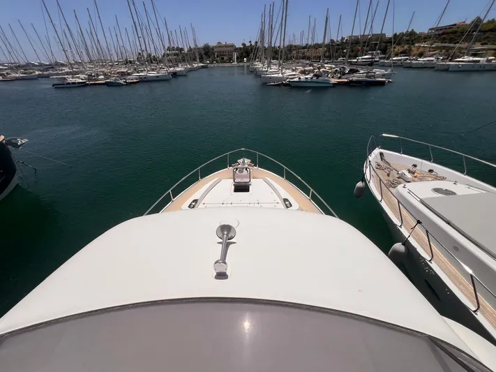  Yacht Photos Pics Bow view of 2018 Absolute 52 Navetta yacht docked in a marina.