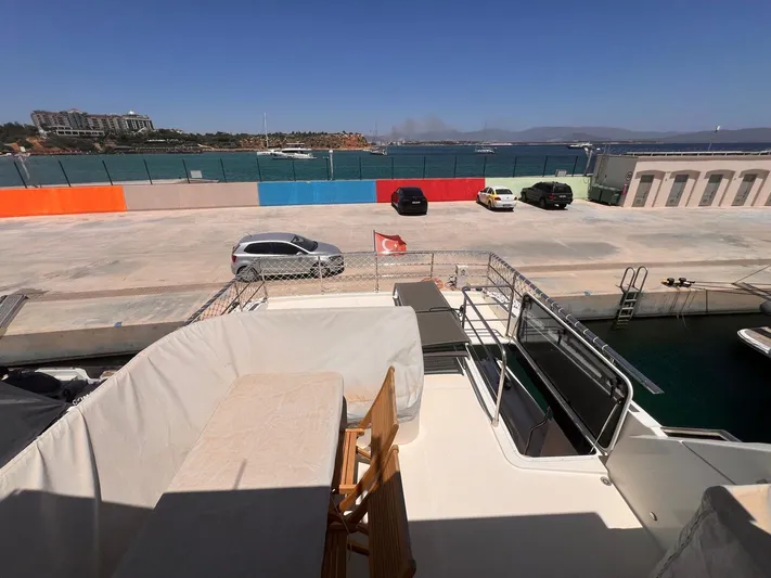  Yacht Photos Pics Deck view from 2018 Absolute 52 Navetta yacht, overlooking marina and parked cars.