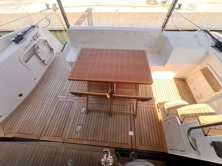  Yacht Photos Pics Luxurious teak deck on 2018 Absolute 52 Navetta yacht with elegant outdoor seating.