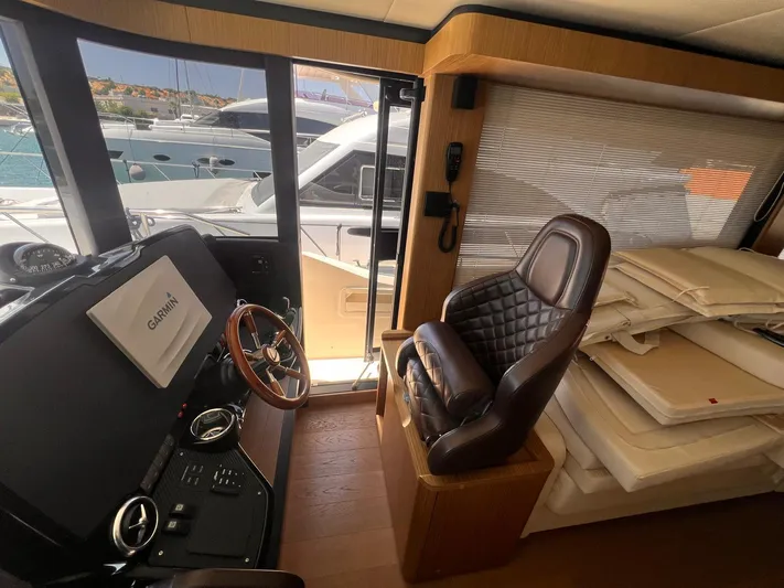  Yacht Photos Pics Interior of 2018 Absolute 52 Navetta yacht with steering wheel and leather seat.