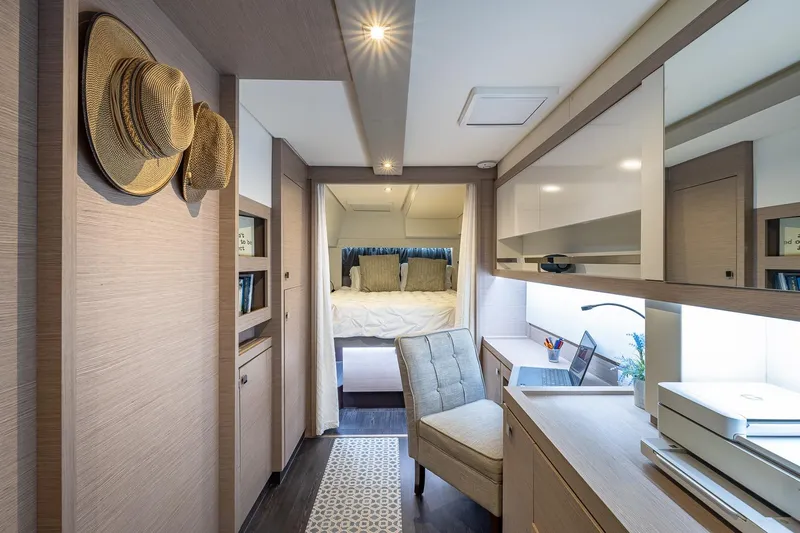 Happy Here Yacht Photos Pics Luxurious interior of 2020 Fountaine Pajot Saona 47 yacht with cozy bedroom and workspace.