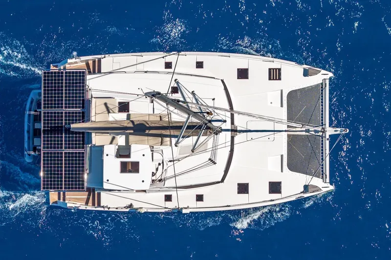 Happy Here Yacht Photos Pics Aerial view of 2020 Fountaine Pajot Saona 47 catamaran sailing on blue ocean.