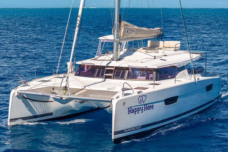 Happy Here Yacht Photos Pics 2020 Fountaine Pajot Saona 47 catamaran sailing on blue ocean waters.