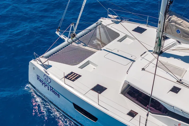 Happy Here Yacht Photos Pics 2020 Fountaine Pajot Saona 47 catamaran sailing on clear blue ocean waters.