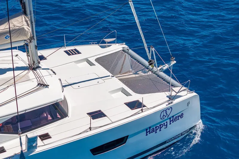 Happy Here Yacht Photos Pics 2020 Fountaine Pajot Saona 47 catamaran sailing on clear blue ocean waters.