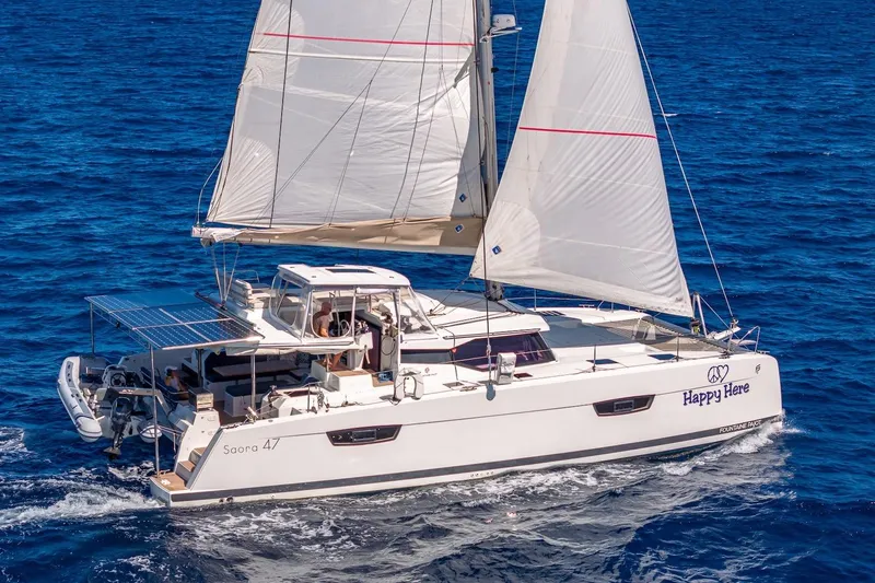 Happy Here Yacht Photos Pics 2020 Fountaine Pajot Saona 47 catamaran sailing on open blue sea.