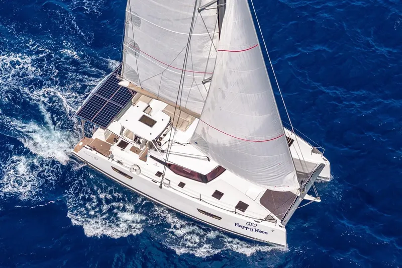 Happy Here Yacht Photos Pics 2020 Fountaine Pajot Saona 47 sailing on vibrant blue ocean waters.