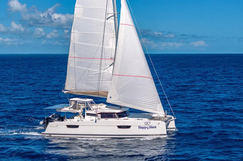 Happy Here Yacht Photos Pics 2020 Fountaine Pajot Saona 47 sailing on open blue ocean under clear skies.