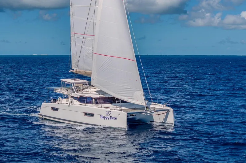 Happy Here Yacht Photos Pics 2020 Fountaine Pajot Saona 47 catamaran sailing on open ocean under clear skies.