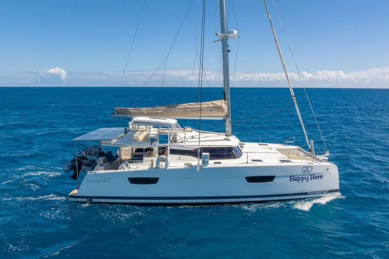 Happy Here Yacht Photos Pics 2020 Fountaine Pajot Saona 47 catamaran sailing on open blue sea.
