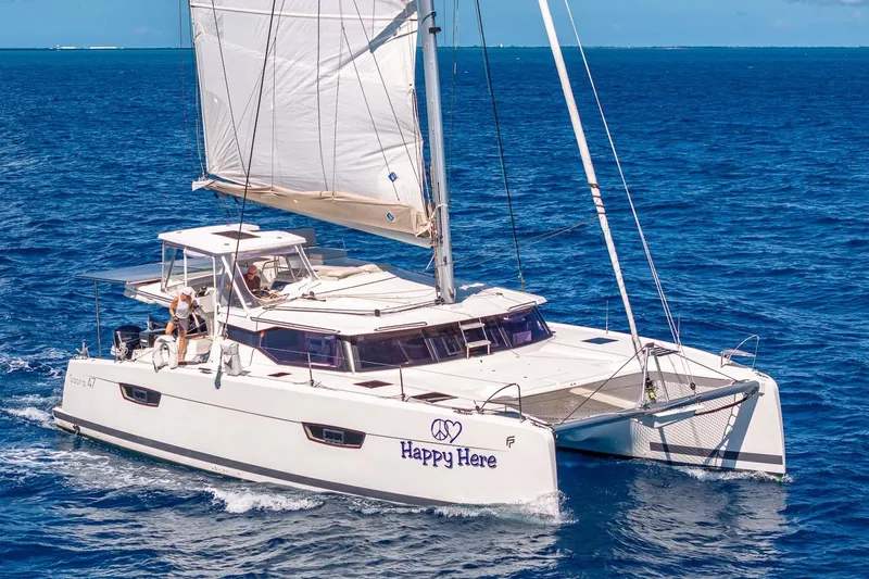 Happy Here Yacht Photos Pics 2020 Fountaine Pajot Saona 47 catamaran sailing on open blue sea.