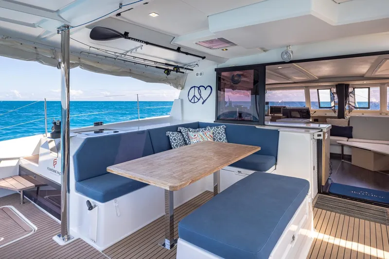 Happy Here Yacht Photos Pics Luxurious 2020 Fountaine Pajot Saona 47 yacht interior with ocean view and comfortable seating.