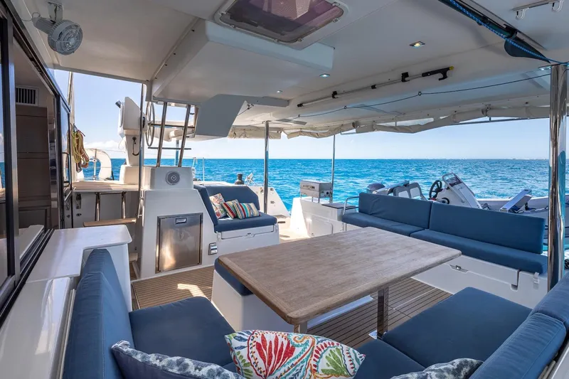 Happy Here Yacht Photos Pics Luxurious 2020 Fountaine Pajot Saona 47 yacht interior with ocean view and elegant seating.